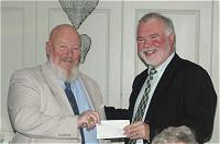 Glen Miller from Emmaus receives cheque from David Heighway. pic HN